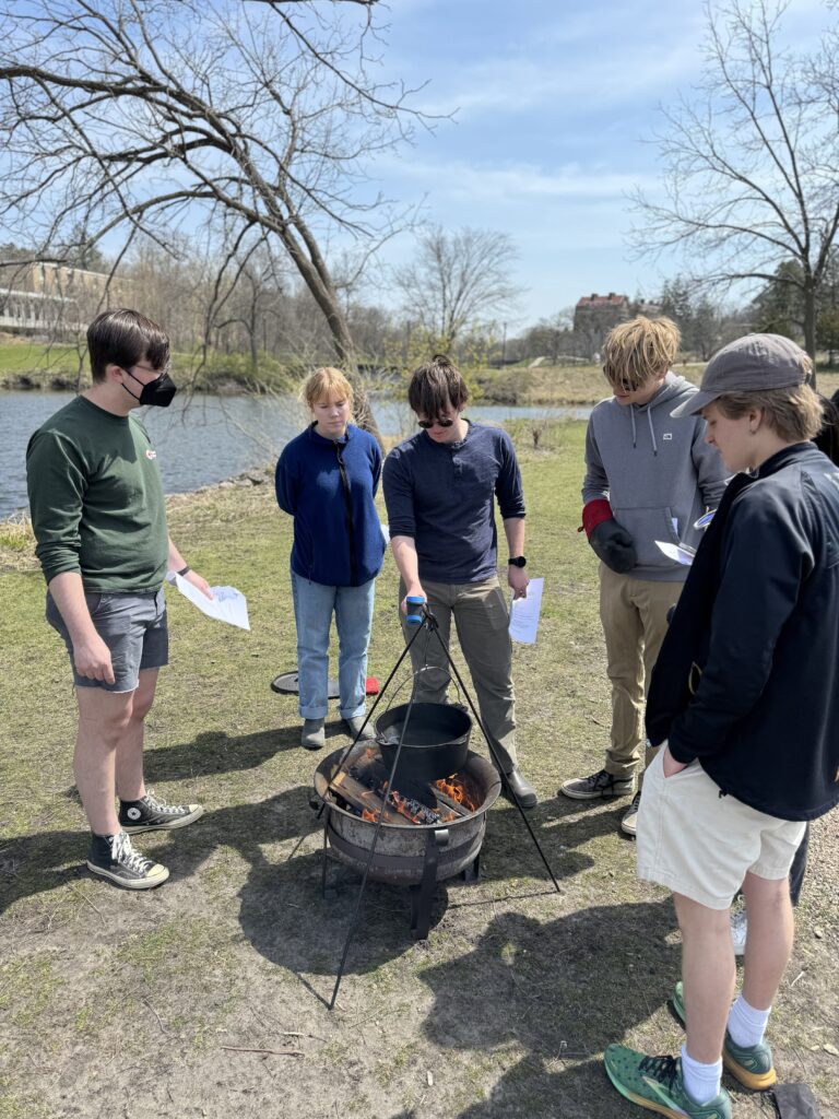 Group of people looking over a fire