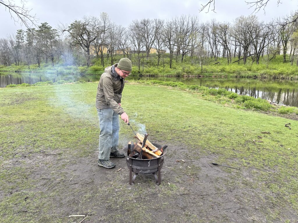 Jack poking at small firepit. 