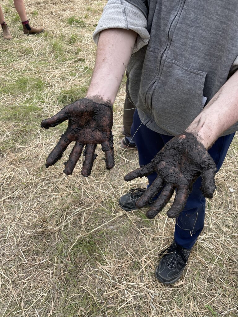 Noah's hands, absolutely covered in mud