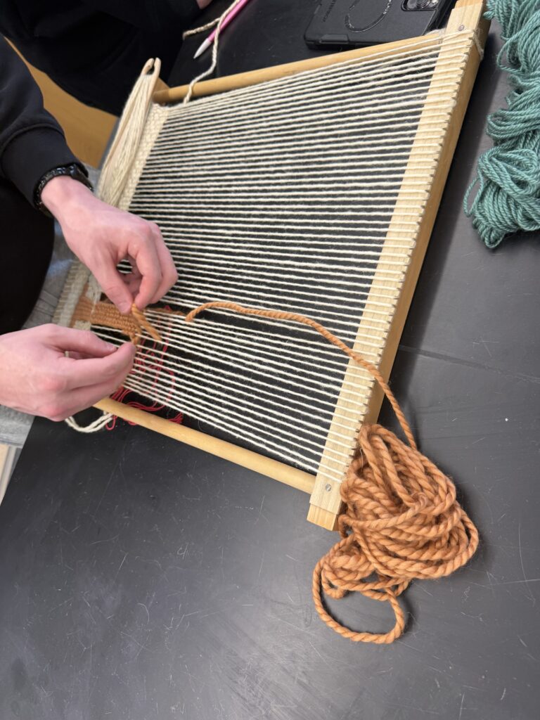Student using tapestry loom